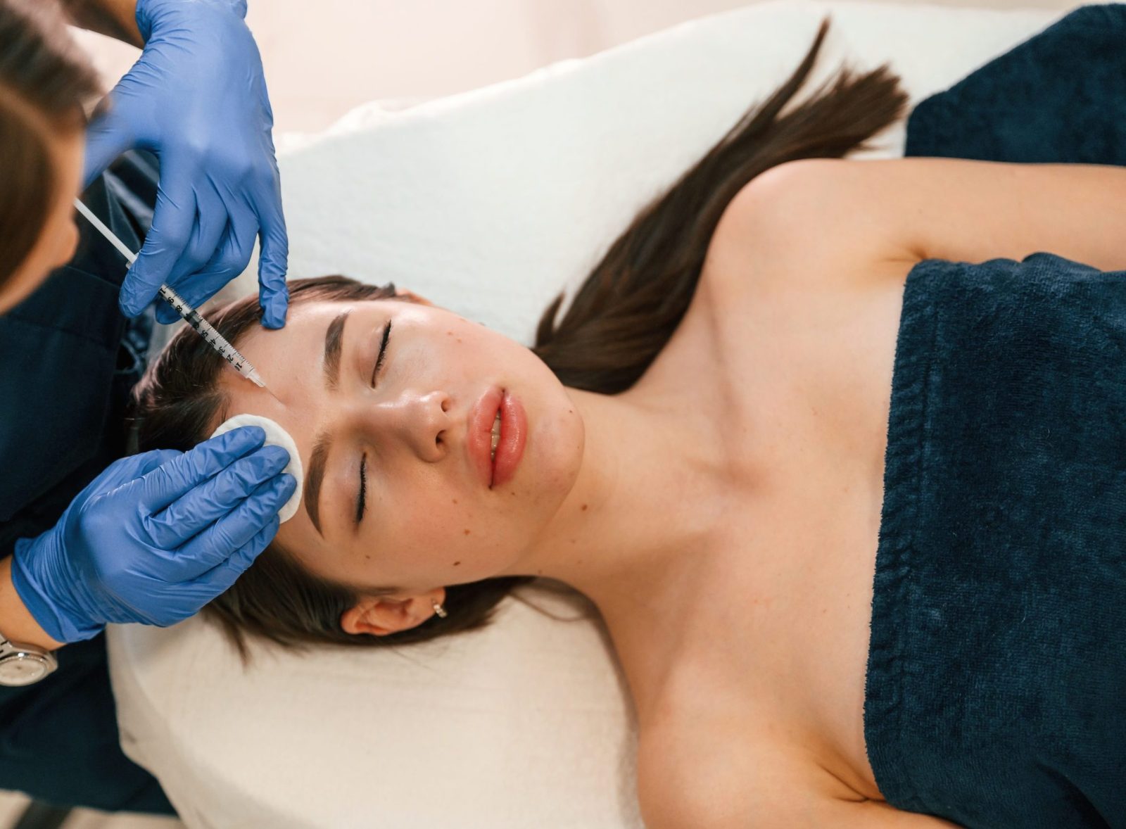 Cosmetologist does injection for lips augmentation. Women's cosmetology in the beauty salon.
