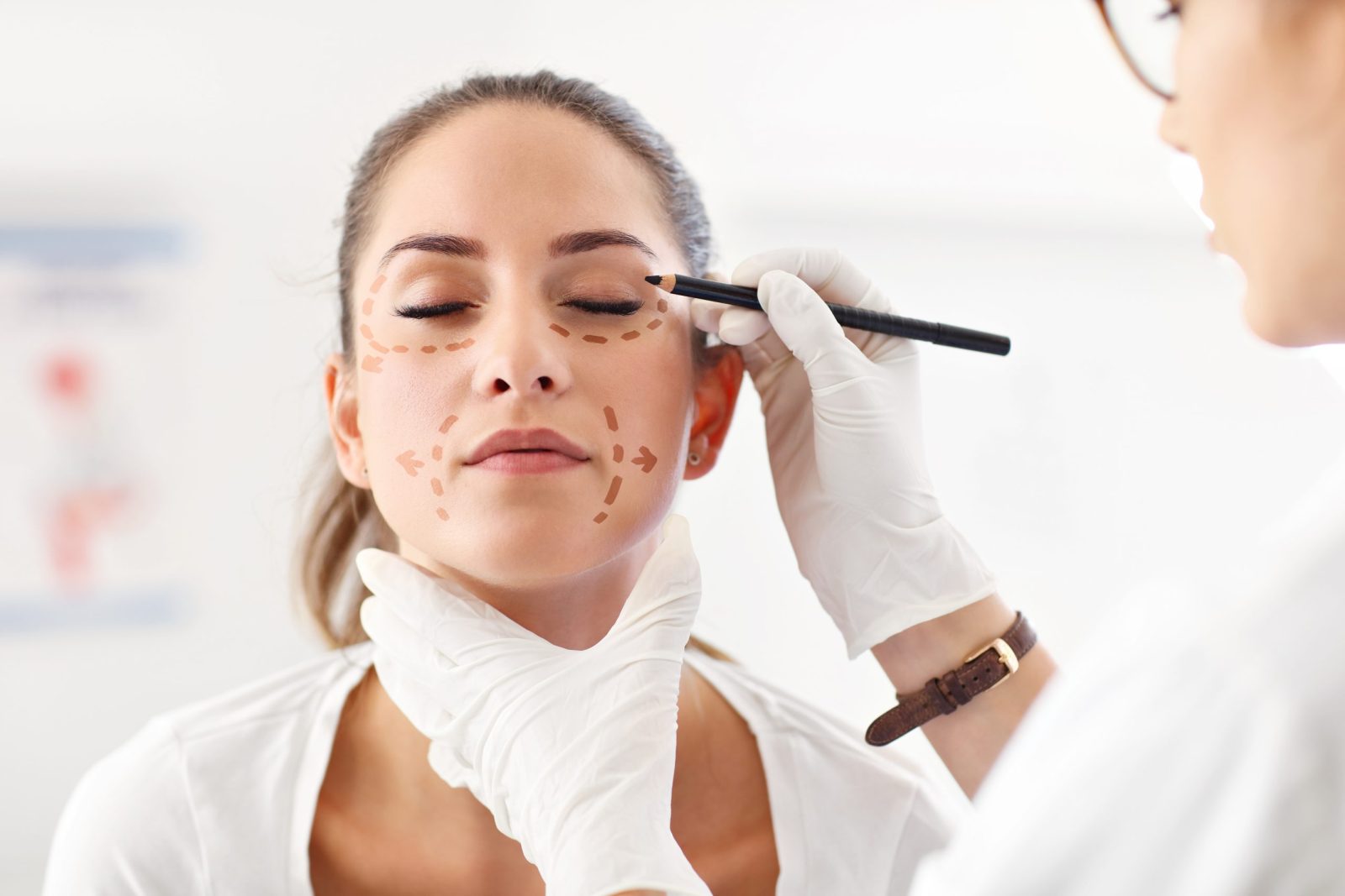 Picture of plastic plastic surgeon making marks on patient's body